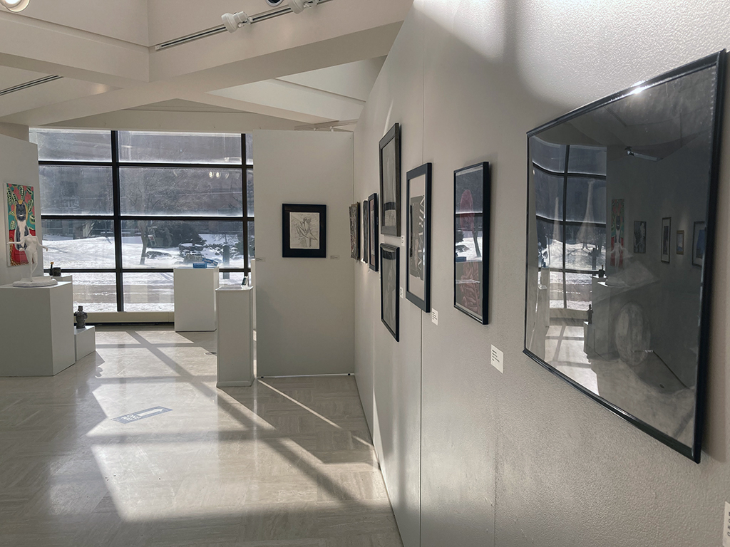 17th Annual Student Art Exhibition backside of inner wall looking south with various artworks shown.